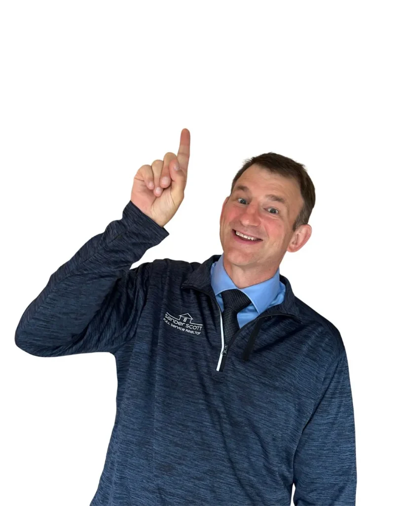 sander-scott-traverse-city-real-estate-expert-northern-michigan-realtor-pointing-up